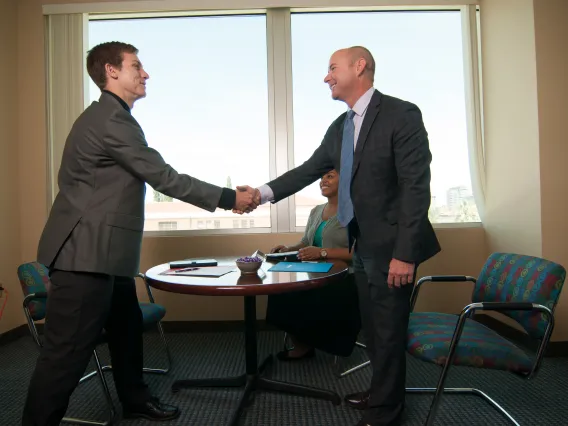 Two people shaking hands for partnership