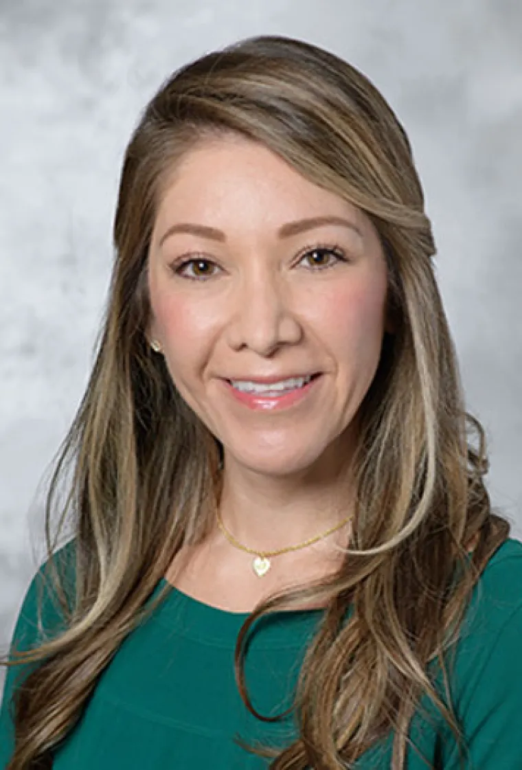 Nicole Paredes smiling in a portrait photo