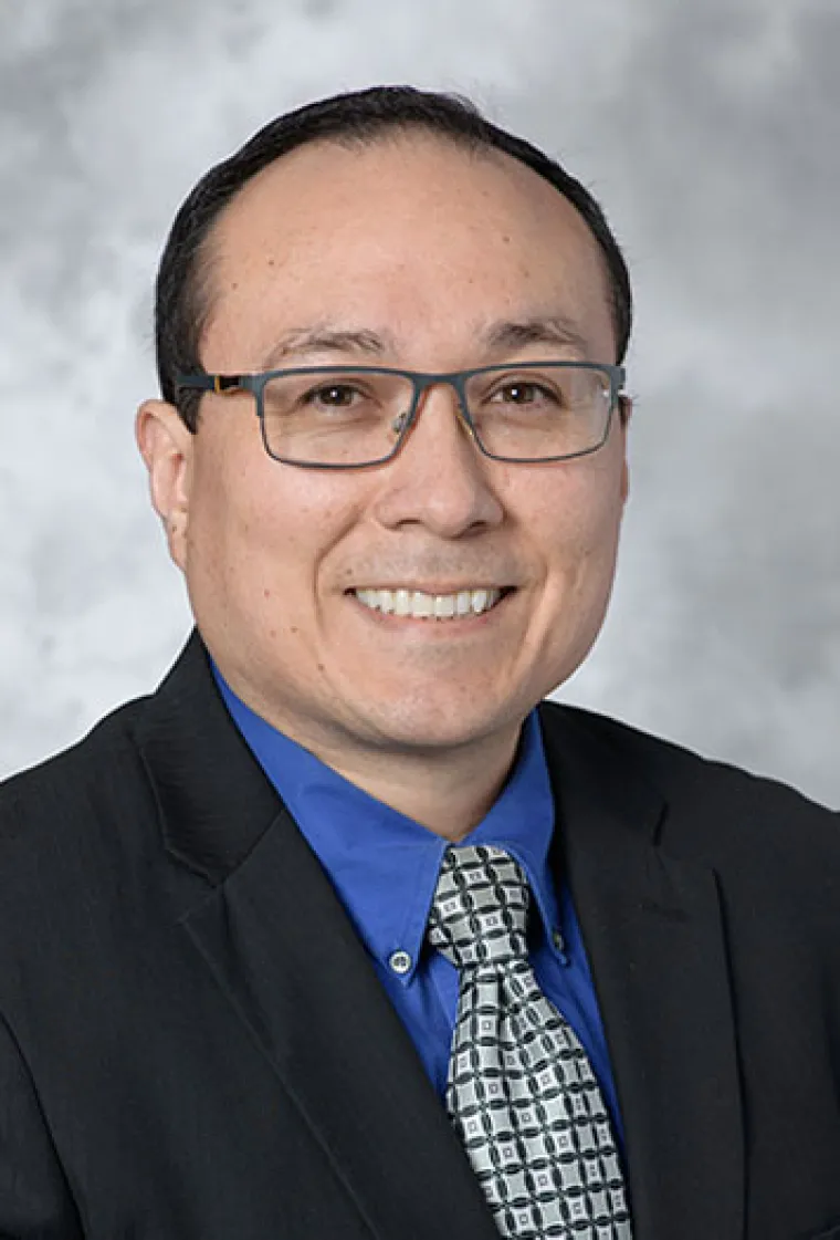 Roy Sanchez smiling in a portrait photo